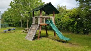 Old style wooden climbing frame with slide 